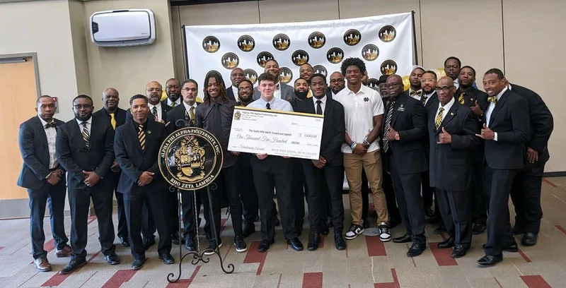 Alpha Phi Alpha members at a youth mentoring program event