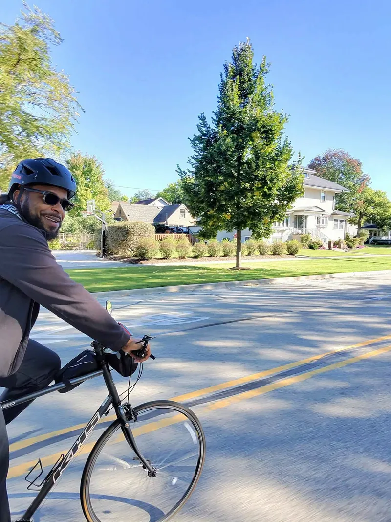 Miguel Jones riding a bicycle on a neighborhood street