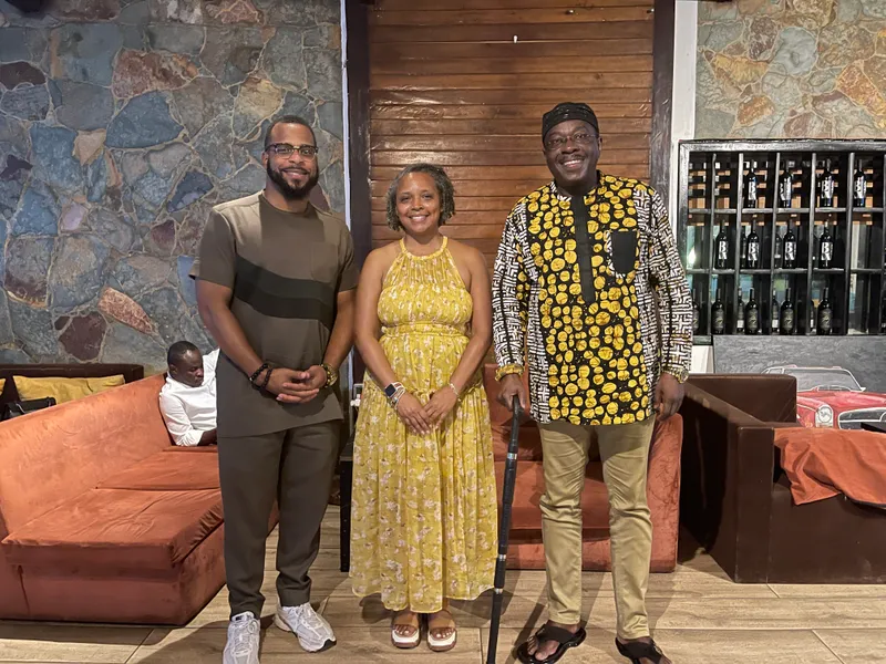 Miguel Jones with two people indoors