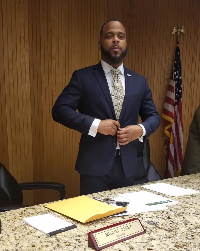 Trustee Miguel Jones at the Maywood Village Board table